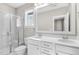 Bright bathroom featuring marble tile shower, dual sink vanity and a big mirror at 1662 Piney Fls Dr, Wendell, NC 27591