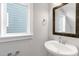 Bathroom featuring vessel sink, framed mirror, and a window at 1662 Piney Fls Dr, Wendell, NC 27591