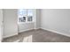 Carpeted bedroom with natural light and a view of the neighborhood at 1662 Piney Fls Dr, Wendell, NC 27591
