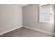 An empty bedroom with neutral walls, carpet, base trim, and a window at 1662 Piney Fls Dr, Wendell, NC 27591