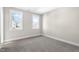 A bright bedroom featuring plush carpet, neutral walls, and double windows at 1662 Piney Fls Dr, Wendell, NC 27591