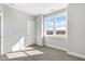 A bright bedroom featuring plush carpet, white trim, and double windows offering abundant natural light at 1662 Piney Fls Dr, Wendell, NC 27591