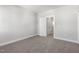 A neutral bedroom featuring plush carpet, and a doorway to another room at 1662 Piney Fls Dr, Wendell, NC 27591