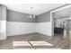 Bright dining room featuring light-gray walls, white wainscoting, and wood-look floors at 1662 Piney Fls Dr, Wendell, NC 27591