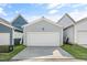 Detached two-car garage with a white door and light-gray siding and a paved driveway at 1662 Piney Fls Dr, Wendell, NC 27591