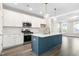 Modern kitchen with white cabinets, stainless steel appliances, and a navy-blue island at 1662 Piney Fls Dr, Wendell, NC 27591