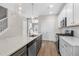 Spacious kitchen with stainless steel appliances, quartz countertop, pendant lighting and wood flooring at 1662 Piney Fls Dr, Wendell, NC 27591