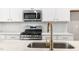 Modern kitchen with stainless steel appliances, white cabinets, and subway tile backsplash at 1662 Piney Fls Dr, Wendell, NC 27591