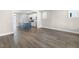 Open-concept living area showcasing modern flooring, neutral walls and a bright kitchen at 1662 Piney Fls Dr, Wendell, NC 27591