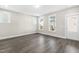 Bright living room featuring modern vinyl floors, white trim, and neutral paint at 1662 Piney Fls Dr, Wendell, NC 27591
