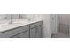 Bathroom featuring double sinks, gray cabinetry, and modern fixtures at 1705 Post Oak Dr, Haw River, NC 27258