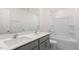 Bathroom featuring double sinks, stylish gray cabinets, and a shower-tub combo at 1705 Post Oak Dr, Haw River, NC 27258