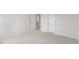Bedroom with neutral carpeting and two white doors at 1705 Post Oak Dr, Haw River, NC 27258