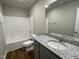 Well-lit bathroom featuring a granite countertop, modern sink and a shower over tub at 181 Pate Landing Dr, Selma, NC 27576