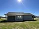 Home's rear facade features a covered patio and well-maintained gray siding at 181 Pate Landing Dr, Selma, NC 27576