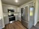 The modern kitchen features gray cabinets, stainless steel appliances, granite countertops, and luxury vinyl flooring at 181 Pate Landing Dr, Selma, NC 27576