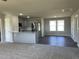 Open concept kitchen with gray cabinets, stainless steel appliances, granite countertops, and vinyl flooring at 181 Pate Landing Dr, Selma, NC 27576