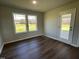 The light-filled living room features vinyl flooring, a glass door to the patio, and a large window at 181 Pate Landing Dr, Selma, NC 27576