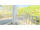 Charming balcony with white railings, offering peaceful views of the surrounding trees and neighborhood at 1828 Parkside Village Dr, Clayton, NC 27520