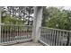 Charming balcony with white railings, offering peaceful views of the surrounding trees and neighborhood at 1828 Parkside Village Dr, Clayton, NC 27520