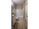Bright bathroom featuring a shower-tub combo with white tile surround, and vanity with sink at 1828 Parkside Village Dr, Clayton, NC 27520