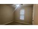 Cozy bedroom featuring a ceiling fan, window, and neutral decor at 1828 Parkside Village Dr, Clayton, NC 27520