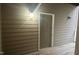 Front door entrance with a covered porch area, featuring a light fixture and unit number at 1828 Parkside Village Dr, Clayton, NC 27520