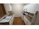 Bright kitchen featuring white cabinetry, modern appliances, and wood-look floors at 1828 Parkside Village Dr, Clayton, NC 27520