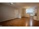 Bright living room with hardwood floors, white trim, and an open layout flowing into the kitchen at 1828 Parkside Village Dr, Clayton, NC 27520