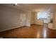 Bright living room with hardwood floors, white trim, and an open layout flowing into the kitchen at 1828 Parkside Village Dr, Clayton, NC 27520