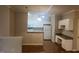View of living room and kitchen with open floor plan and wood flooring at 1828 Parkside Village Dr, Clayton, NC 27520