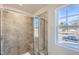 Modern tiled shower with glass door, offering ample space and natural light from a nearby window at 197 S Finley Landing Parkway # 85, Smithfield, NC 27577