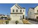 Charming two-story home with a white exterior, a two-car garage, and a well-manicured lawn at 197 S Finley Landing Parkway # 85, Smithfield, NC 27577