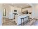 Open kitchen featuring sleek white cabinetry, a central island, and modern stainless steel appliances at 197 S Finley Landing Parkway # 85, Smithfield, NC 27577