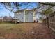 Spacious backyard with a deck, green grass, and a wooden fence, perfect for outdoor activities at 209 James St, Apex, NC 27502
