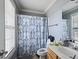 Cozy bathroom featuring a shower with blue patterned curtain and a well-lit vanity at 209 James St, Apex, NC 27502