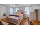 Inviting bedroom with a tufted headboard bed, hardwood floors, and neutral decor at 209 James St, Apex, NC 27502
