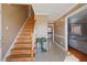 Inviting foyer with wood staircase and neutral decor at 209 James St, Apex, NC 27502