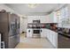 Contemporary kitchen with stainless steel appliances and neutral tile flooring at 209 James St, Apex, NC 27502
