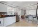 Bright kitchen featuring white cabinets, stainless steel appliances, and dining area at 209 James St, Apex, NC 27502