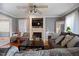 Bright living room featuring a fireplace, large windows and hardwood floors at 209 James St, Apex, NC 27502