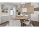 Stylish dining room with modern artwork and light fixture, adjacent to kitchen at 3402 Pelican Ln, Durham, NC 27703
