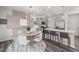 Open-concept kitchen and dining area with a granite island and modern decor at 3402 Pelican Ln, Durham, NC 27703
