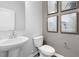Bathroom with pedestal sink, toilet, and framed art at 3406 Pelican Ln, Durham, NC 27703