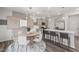 Open-concept dining area features stylish lighting and a modern table set for six at 3406 Pelican Ln, Durham, NC 27703
