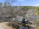 Aerial view of a home nestled among lush trees, beside a serene lake at 4041 Wendy Ln, Zebulon, NC 27597
