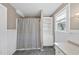 Cozy bathroom featuring a shower, built-in shelving, and plenty of natural light at 4041 Wendy Ln, Zebulon, NC 27597