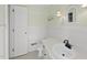 Charming bathroom with beadboard walls, a pedestal sink, and white fixtures and door at 4041 Wendy Ln, Zebulon, NC 27597