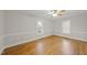 Large, light-filled bedroom featuring hardwood floors, ceiling fan, and two large windows at 4041 Wendy Ln, Zebulon, NC 27597