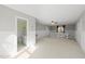 Spacious bonus room featuring neutral carpet, wood paneling, and a ceiling fan, with a bathroom entrance at 4041 Wendy Ln, Zebulon, NC 27597